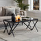 black glass coffee table with geometric legs in room